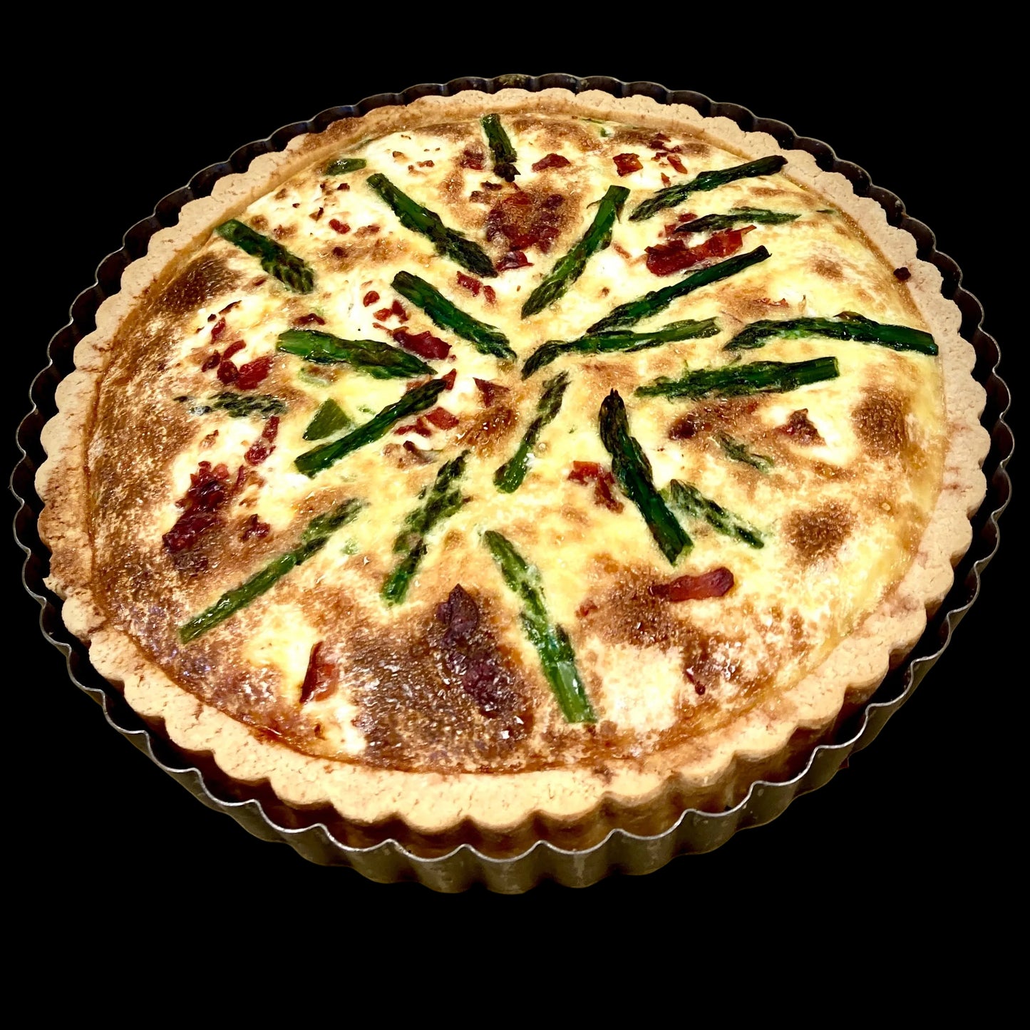 asparagus and prosciutto tart on a baking mold
