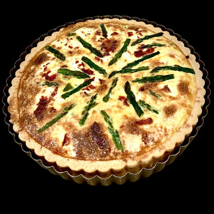 asparagus and prosciutto tart on a baking mold 