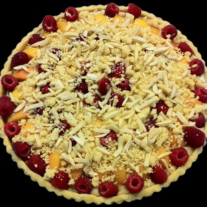 Unbaked tart with fruit and crumb topping on a metal surface