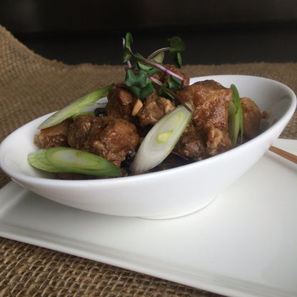 Filipino adobo style chicken thigh slow braised with onion, garlic, black pepper, bay leaf, soy sauce, coconut milk and vinegar.